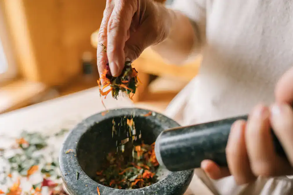 Herbalist preparing a custom tincture blend during a consultation