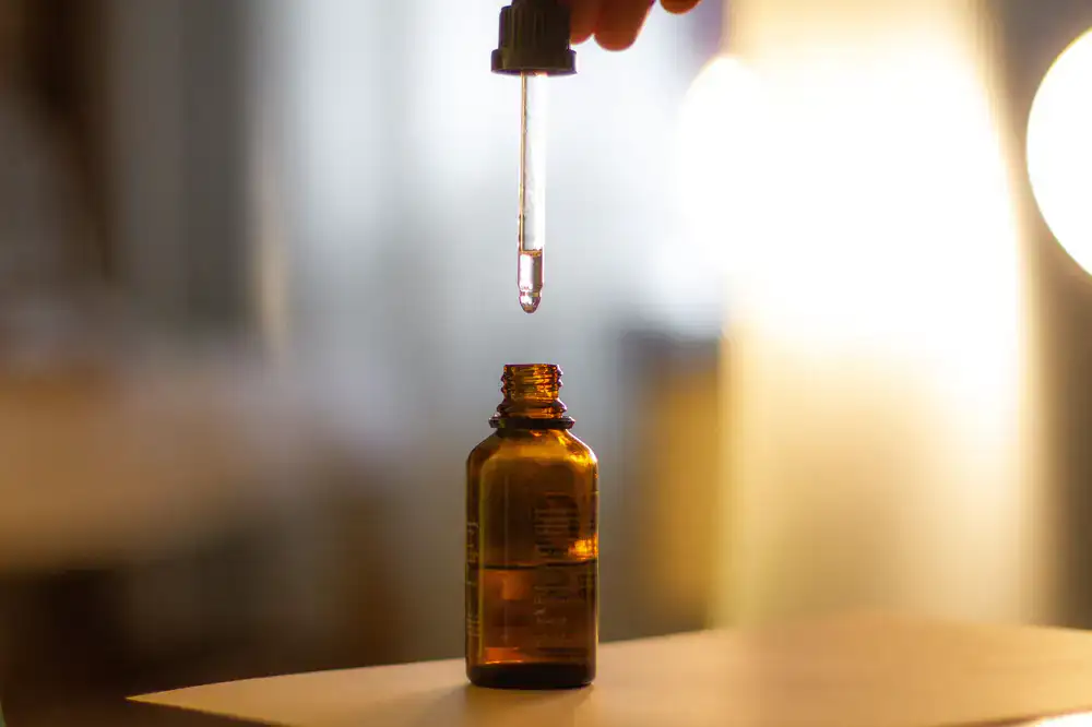 Dropper bottle with dark amber liquid