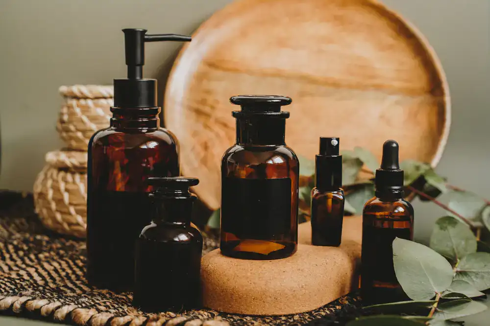 Amber glass jars lined up on a wooden apothecary shelf